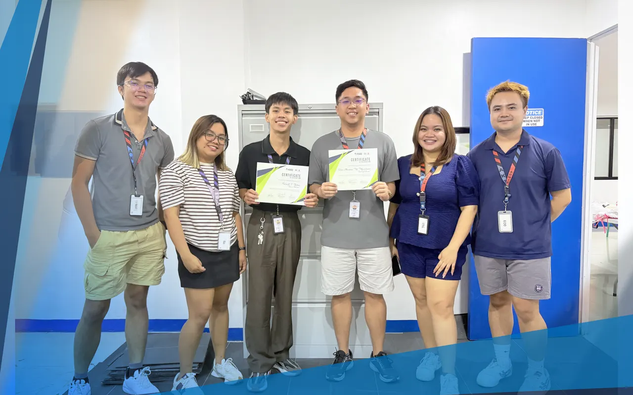 Six team members, two of them holding certificates of recognition