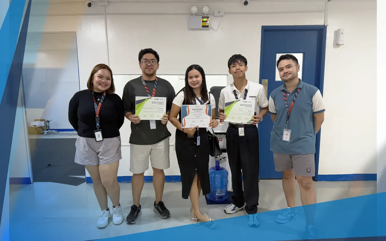 Five team members, three of them holding certificates of recognition